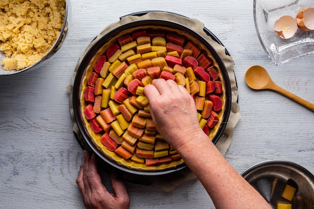 Sheet pan filled with golden roasted chicken sausage rounds surrounded by colorful roasted vegetables